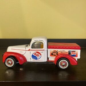 1940’s Ford Pepsi Cola die cast truck toy. Still rolls, axels move, hood lifts.